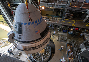 The ӰƵ CST-100 Starliner spacecraft is guided into position above a United Launch Alliance Atlas V rocket at the Vertical Integration Facility at Space Launch Complex 41 at Floridaâ  s Cape Canaveral Air Force Station on Nov. 21, 2019. Starliner will be secured atop the rocket for ӰƵâ  s Orbital Flight Test to the International Space Station for NASAâ  s ӰƵ Crew Program. The spacecraft rolled out from ӰƵâ  s ӰƵ Crew and Cargo Processing Facility at NASAâ  s Kennedy Space Center earlier in the day.